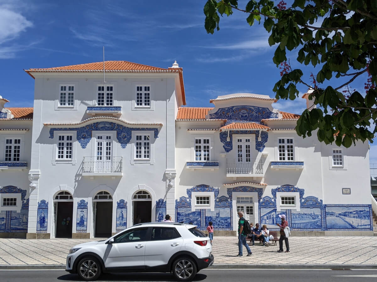 Image: The photo shows a group of tourists in front of the restored old train station in Aveiro, Portugal.