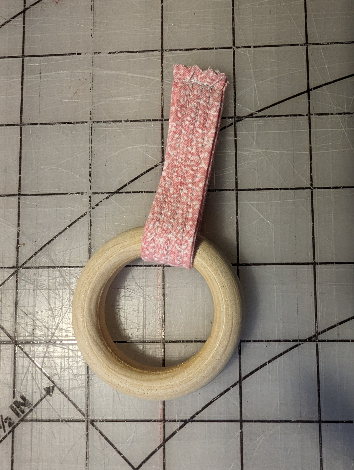 Loop fabric folded and sewn around the wooden ring