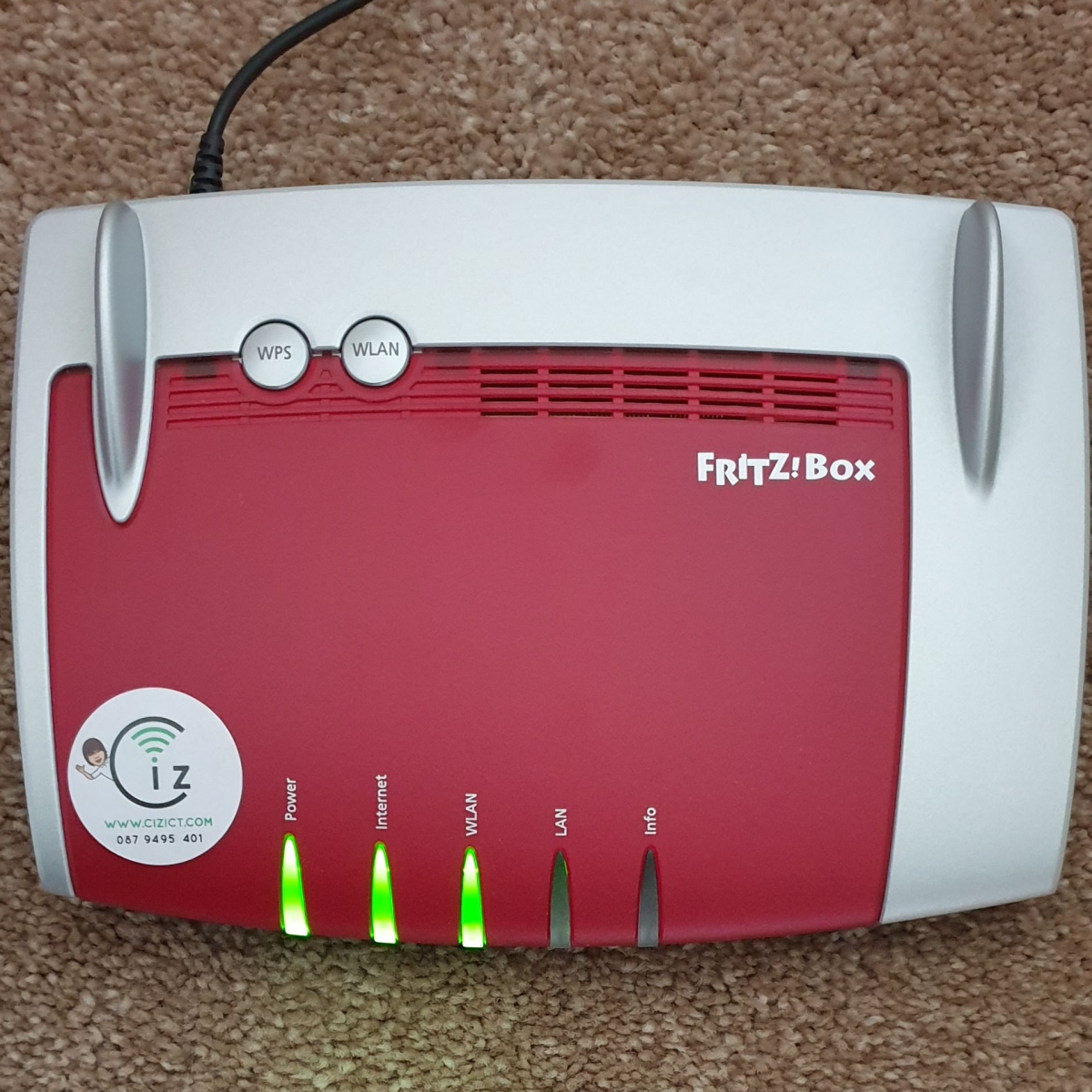 A Fritzbox 4040 Wireless Router with Ciz ICT logo
