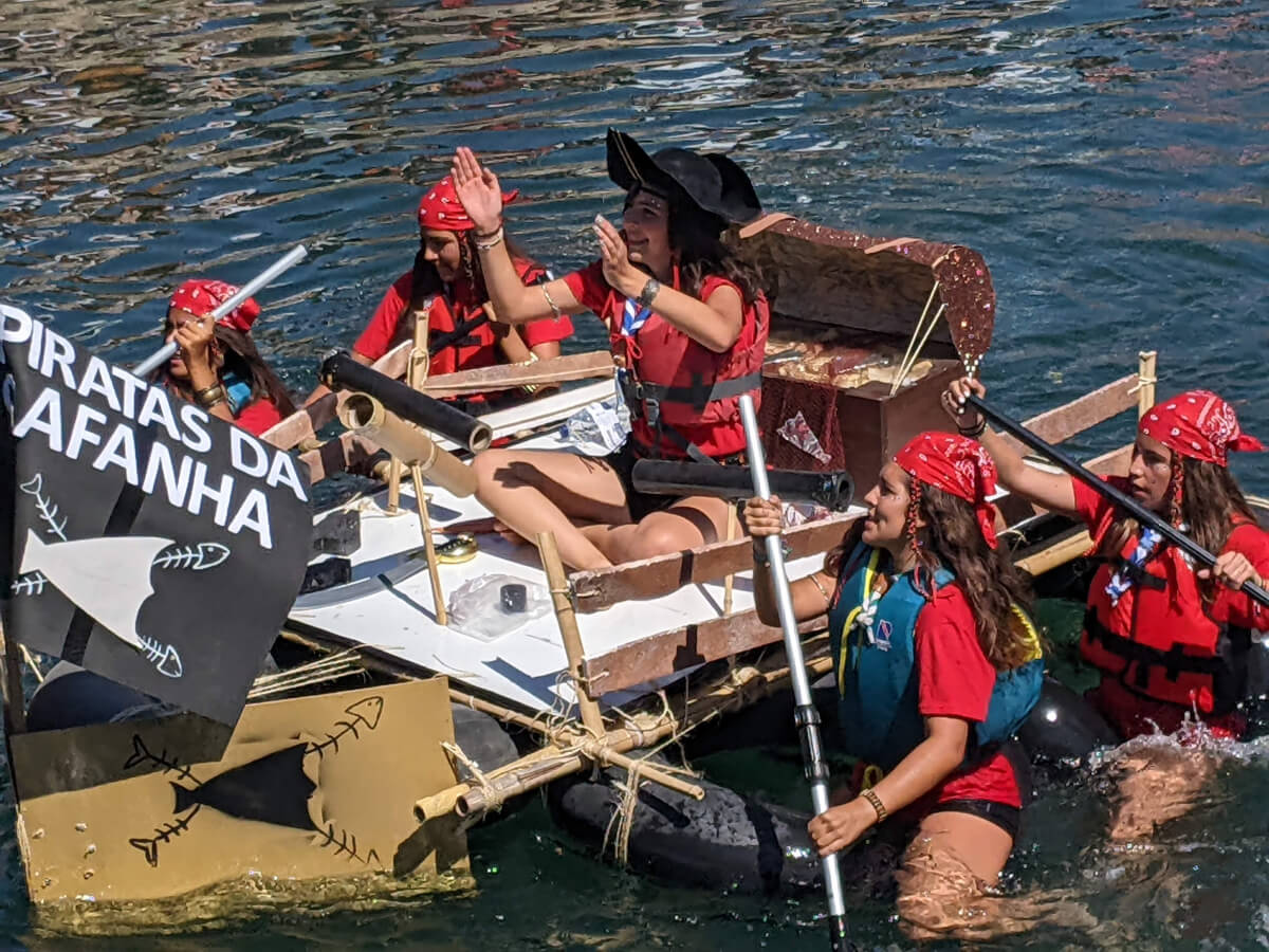 Image: The photo shows five young women from Gafanha (Aveiro District) in Portugal competing with a homebuilt raft in The Ria's Craziest Regatta (Corrida mais Louca da Ria)