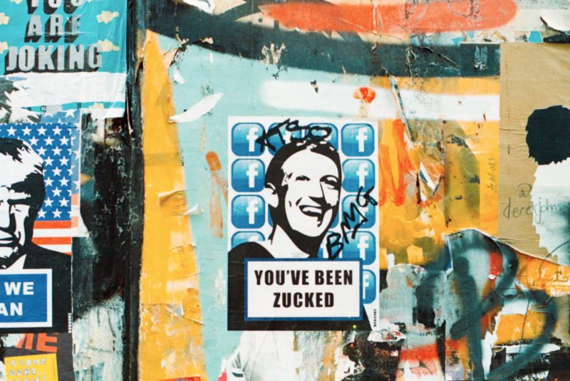 A street mural with a poster that reads, 'You've been Zucked.'