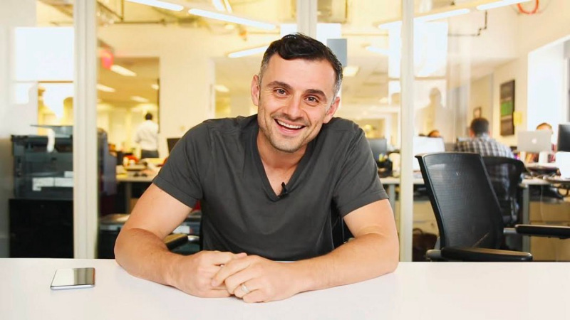 Gary Vaynerchuk sitting and smiling in his office.