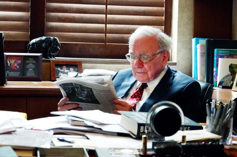 Warren Buffett reading in his office.